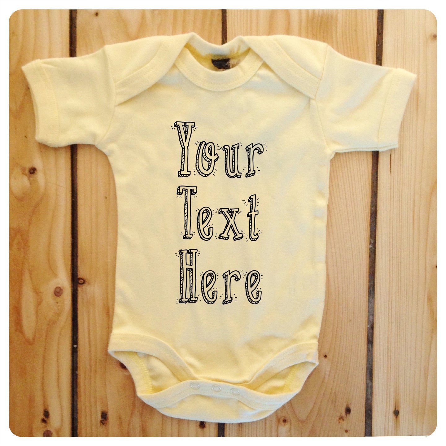 Personalised babygrow / baby onesie available in grey, blue, yellow & white (drop shadow text)