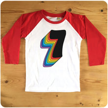 Load image into Gallery viewer, Seventh Birthday Seven Raglan T-Shirt With Retro Rainbow Drop Shadow available in red or blue